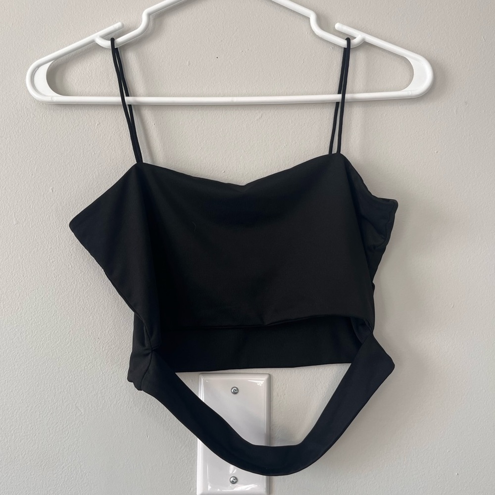 Black cropped tank top with strap in front.